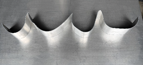 Curved aluminum channel letter returns bent to shape by the Ascent MAX