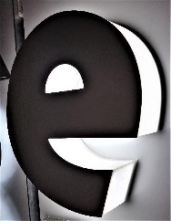 Trim-less channel letter E with black face and illuminated side return produced by the Ascent 5AS