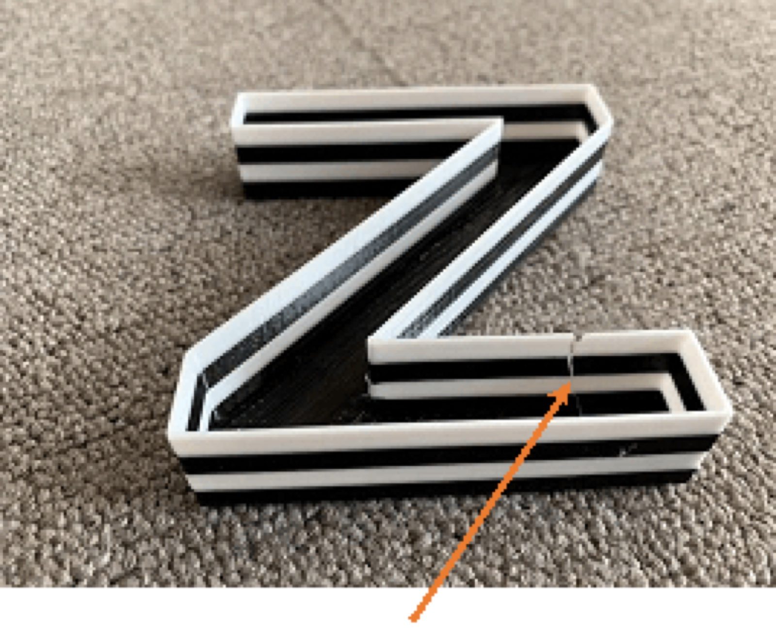 Normal PLA filament — letter breaks when squeezed during PMMA panel install